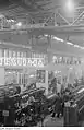 A Demag crane suspended above a factory floor handling textile machines in a company called Textima. Photographs by Roger and Renate Rössing from 1951