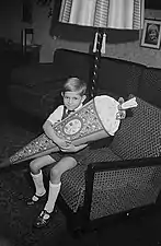 A schoolboy with a Schultüte and wearing T-bar sandals in Leipzig, East Germany, 1951.