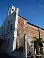 The church's painted facade and brick-laid walls