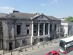 Exterior shot of grand neo-classical theatre in urban setting