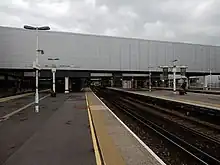 Outdoor station with enclosed, overhead walkway