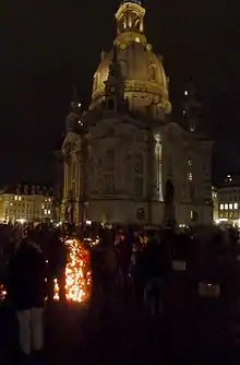 Church at night, with many people and candles