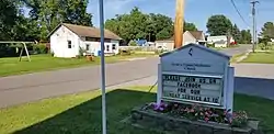 Geneva United Methodist Church sign and Mary's Grocery Store, facing north on Vandalia Road