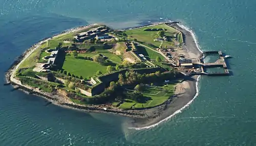 Small island with a star-shaped fort taking up much of its area and a beach on one side