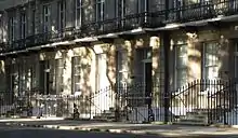 A Georgian-style terrace house (townhouse) with the number 21 on one of its doors