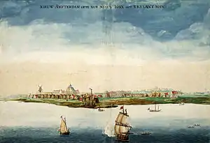 A painting of a coastline dotted with red roof houses and a windmill, with several masted ships sailing close to shore under blue sky