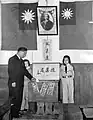 The Nationalist Party flag on the left of Sun Yat-sen's portrait has been replaced by the national flag, signaling the end of the political tutelage period.