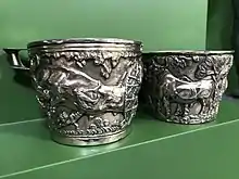 Two silver-coloured cups, in the style of the Mycenaean Vapheio Cups