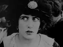 Black-and-white close-up of a woman with an alarmed expression