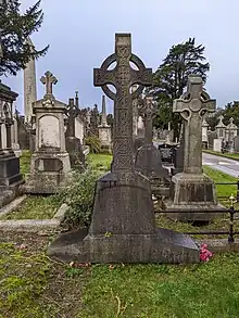 The grave of James Murphy with a large celtic cross.