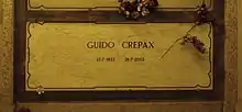 A marble gravestone on the wall of a crypt