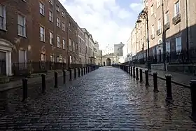 Cobbled street with brick buildings around