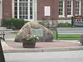 Rock deposited by glaciers in the center of the square