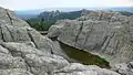 A man-made dam is located near the summit.