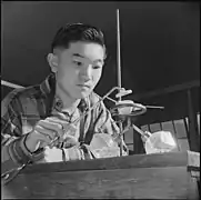 Harry Ishigaki conducts an experiment in Chemistry in the laboratory of the Heart Mountain High School.