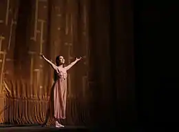 Photograph of Seo with her arms out during the curtain call for Romeo and Juliet on 19 June 2015