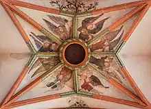 Gothic Holy Ghost hole framed by 15th-century frescos at Church of the Holy Spirit, Heidelberg.