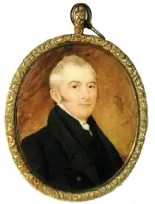 19th century oval-shaped portrait miniature of a man, head and shoulders, with light hair and a dark coat