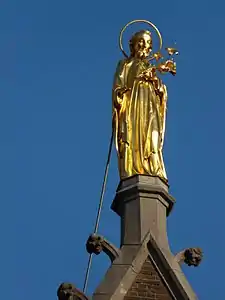 Copper-gilded statue of Saint Joseph on top of the front facade