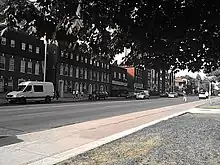 group of buildings alongside a large street with many cars