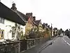 A series of terraced houses to the left of a road.