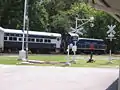 The Heart of Dixie Railroad Museum excursion train departs past the display of railroad signals.