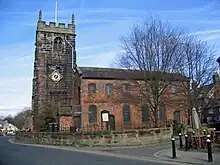 A church with a Neoclassical brick body and a stone Gothic tower