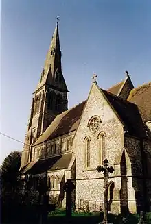 A stone church with a south transept, clerestory and a broach spire