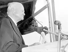 A man (former President Herbert Hoover), speaking behind a podium