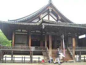 Lower shutters from central three bays (inter-pillar spaces) have been lifted out and stacked against the outermost bays