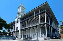 A three-storey building with verandas and a bell tower