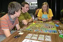 Two boys and a girl playing the game