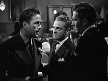 Close up shot of three men in a room talking