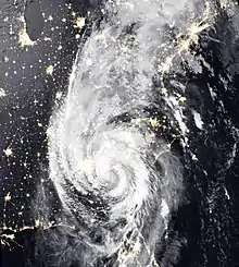 Nighttime satellite image of Michael and its circular rainbands over the Eastern US, with city lights visible