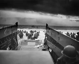 Allied troops storming the Normandy beaches from several landing craft