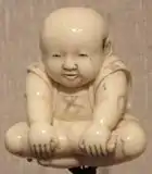 Ivory netsuke with sitting boy