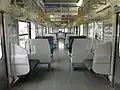 Interior of 209-2100 series car with transverse seating in June 2012