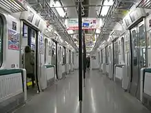 Interior view of SaHa E230-500 car with seats folded up for the rush hour