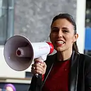 Ardern speaking into a megaphone