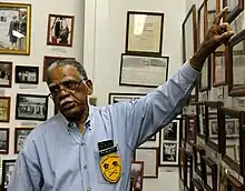 A man in Sky Blue shirt wearing glasses