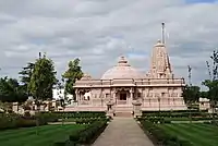 Jain Temple at the Oshwal Centre, Potters Bar, Hertfordshire, which "recreates a general Māru-Gurjara aesthetic". Side view.