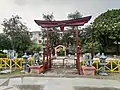 A gate of park inside japanese garden where many small momunents are placed