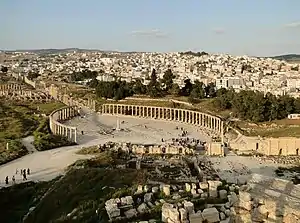 The Greco-Roman city of Gerasa and the modern Jerash in the background.