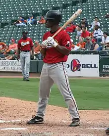 A baseball player in red and gray