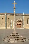 Cruzeiro (a Stone cross) and façade of the Monastery of Jesus of Setúbal.