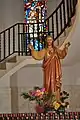 Statue of Jesus and the stairs that lead up to the balcony inside the Church