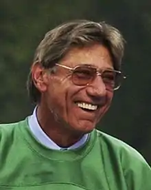 Joe Namath wearing glasses and a green shirt.