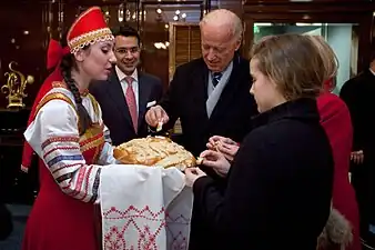 Joe Biden, Jill Biden, and Finnegan Biden participate in a bread and salt welcoming ceremony in Ritz Carlton, March 8, 2011.