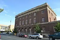 photograph of a three-story, monumental, brick building