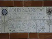 A tablet formed of five tiles of varying sizes, bordered by yellow and blue flowers in an art nouveau style